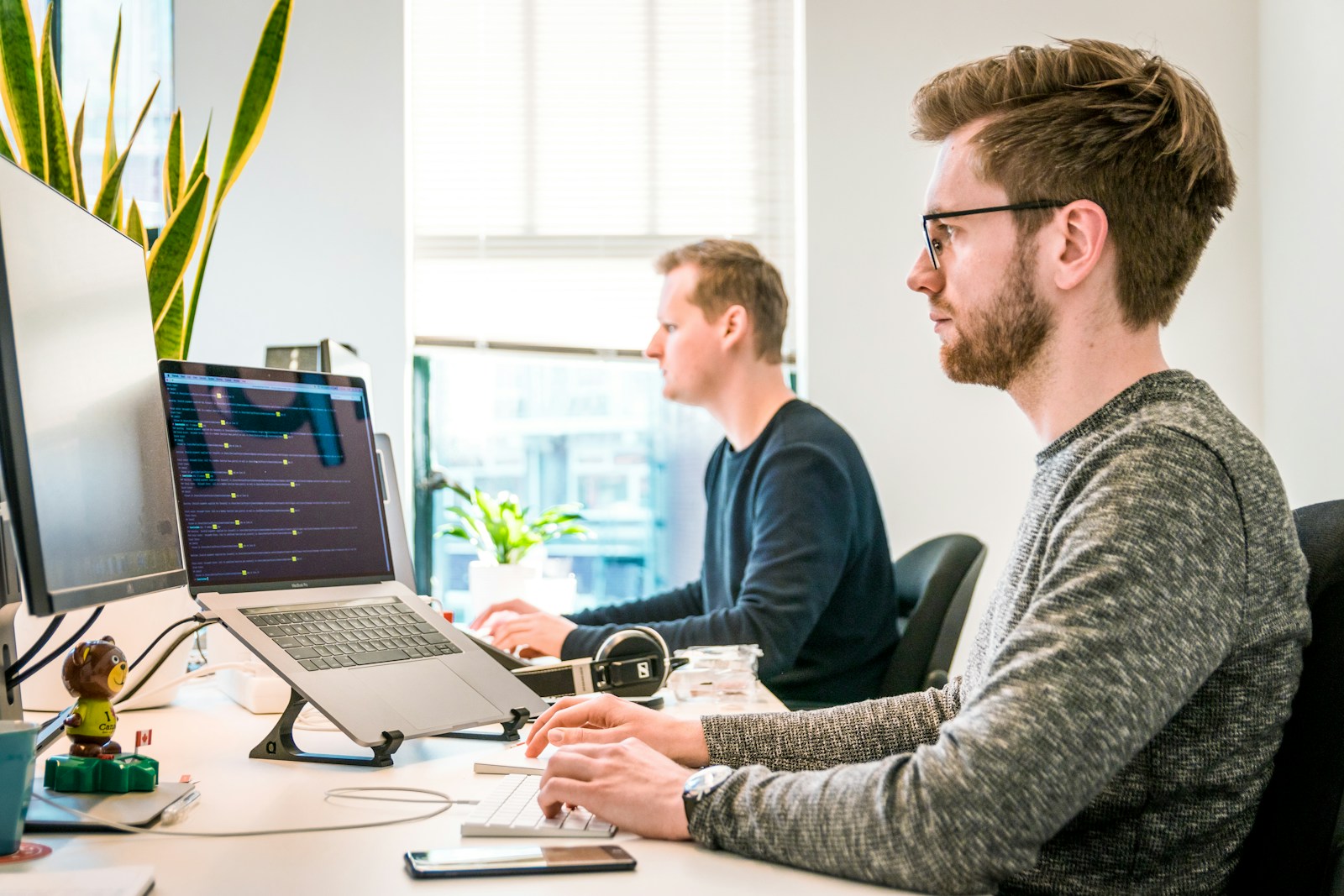 Engineers collaborating around a screen
